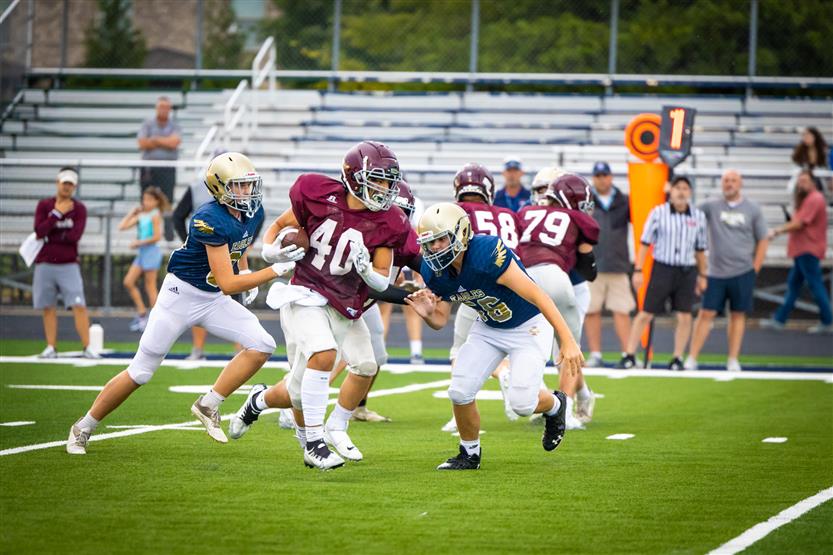 Football players play on the field